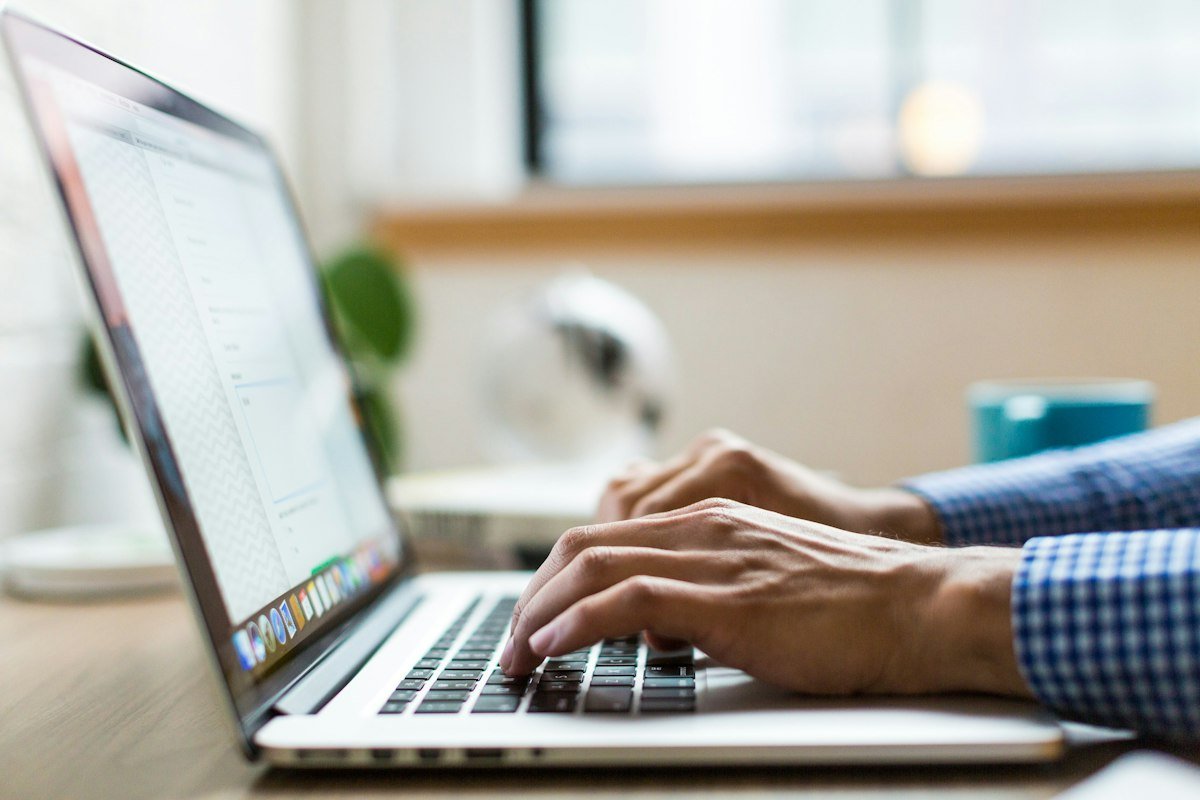 Student writing an Upwork proposal on a laptop